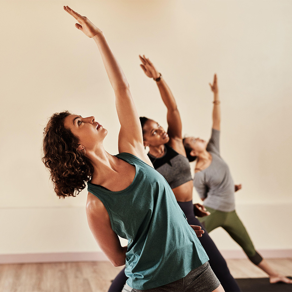 2K2F7N4 - Life is all about balance. Shot of a group of young men and women practicing yoga in a fitness class.