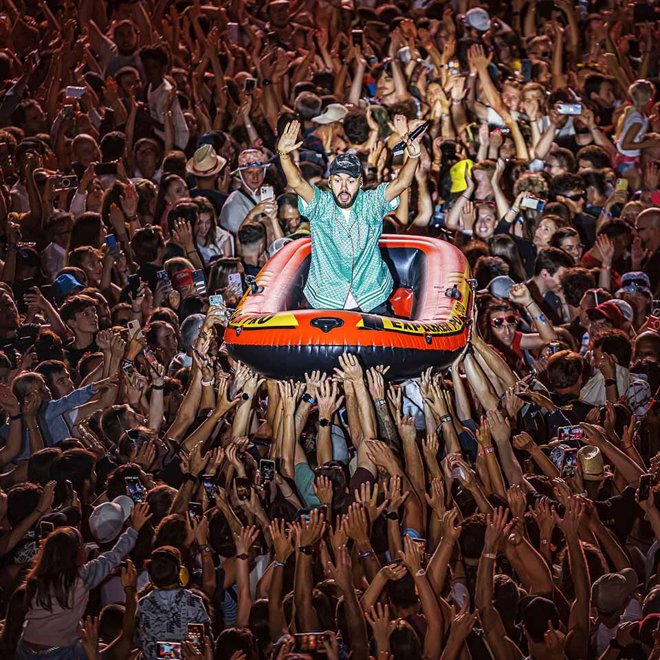 2REJG6X - Olivio Ordonez from the French hip hop duo "Bigflo & Oli" (Bigflo et Oli) crowd surfs in an inflatable boat as they perform on the main stage during the 46th edition of the Paleo Festival in Nyon, Switzerland, Friday, July 21, 2023. 